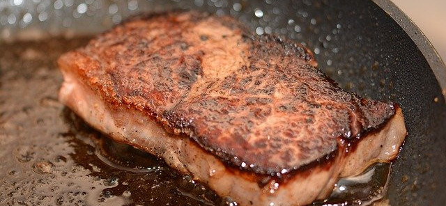 salmon searing in pan